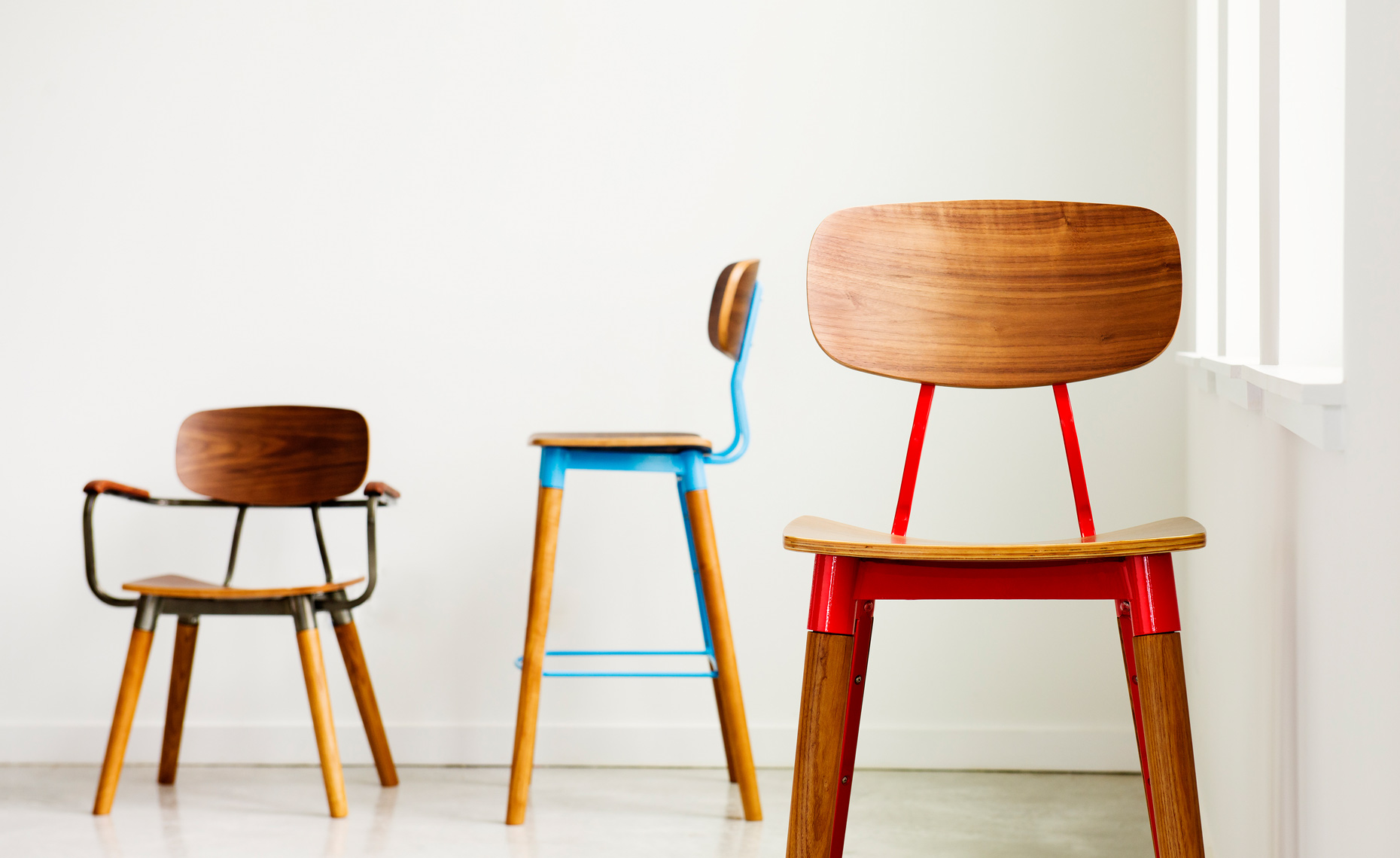 collection of yellow, blue, and red wood barstools and chairs