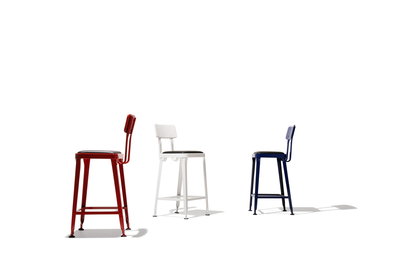 Three red, white, and blue chairs on white